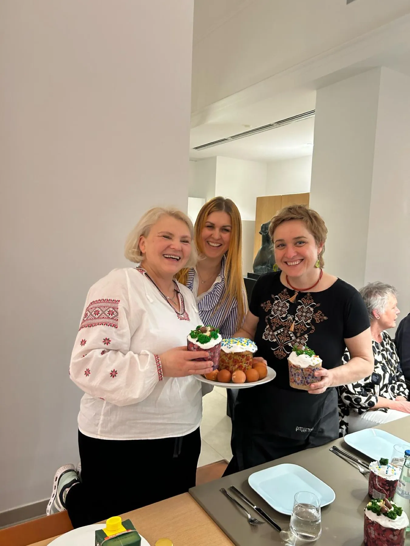 Participants hold freshly decorated Ukrainian Easter bread after the workshop.